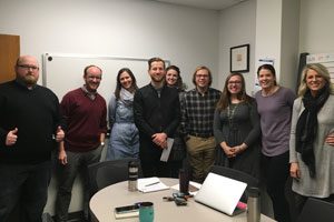 Marketing and Events gather in a group photo to celebrate John's award